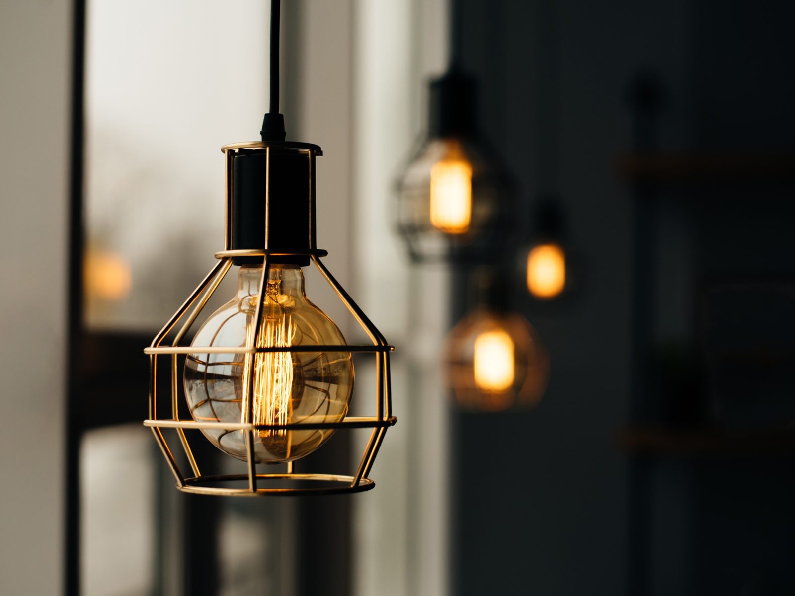 A light bulb inside a metal cage.
