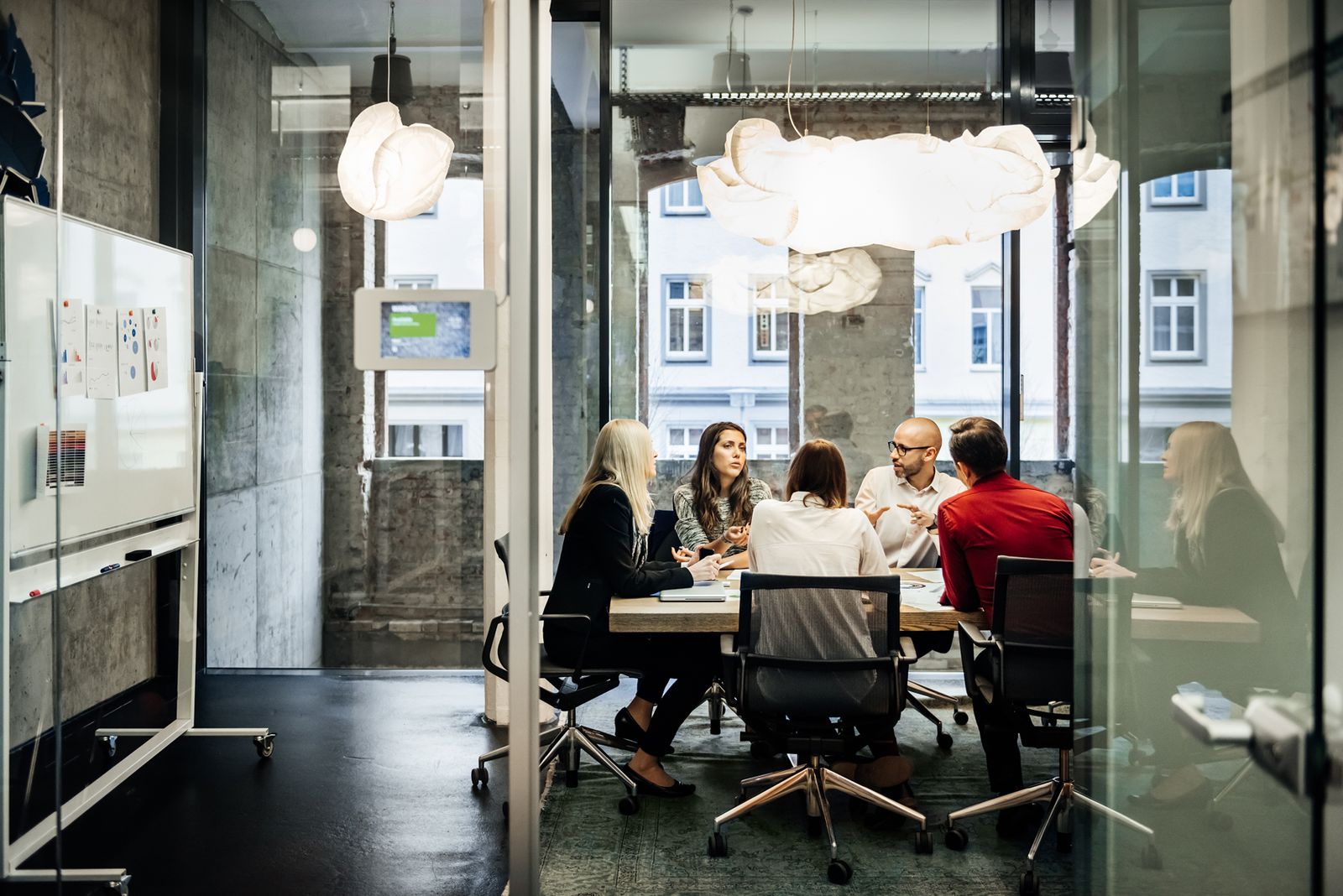 A university leadership team working together around a table.