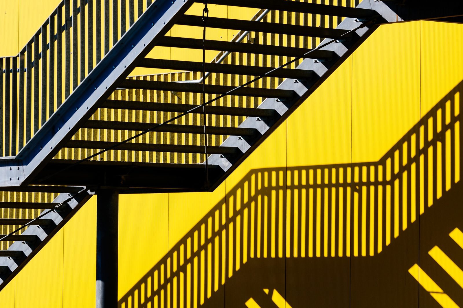 A yellow staircase seen from below.